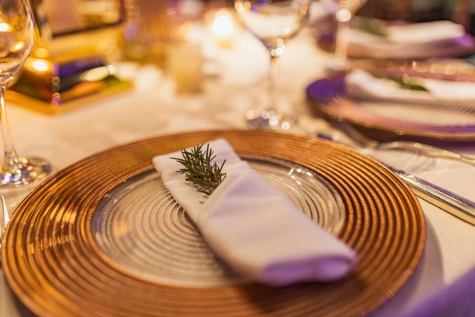 A macro shot of a sophisticated restaurant menu, focusing on the high-quality paper, elegant typography, and layout design, resting on a clean tabletop.