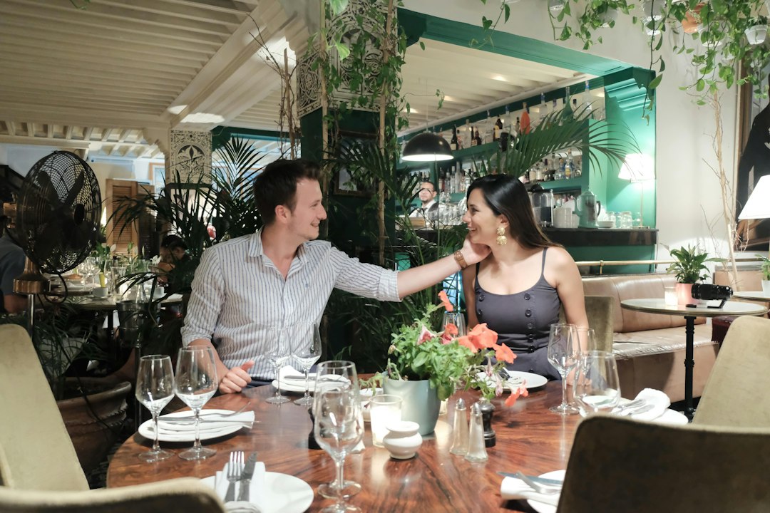 A diner at an elegant restaurant looks closely and thoughtfully at their expensive meal, symbolizing consumer awareness about food quality and safety.