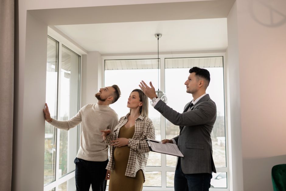 A professional and friendly Northshore realtor uses a tablet inside a bright, modern home, showcasing the efficiency and technology of innovative real estate services like 1 Percent List HUB.